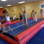 Kids exercise and have fun during summer camps at The Little Gym