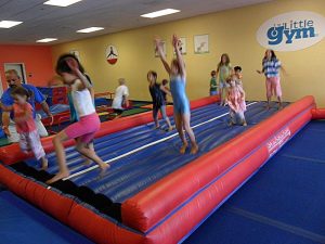Kids exercise and have fun during summer camps at The Little Gym